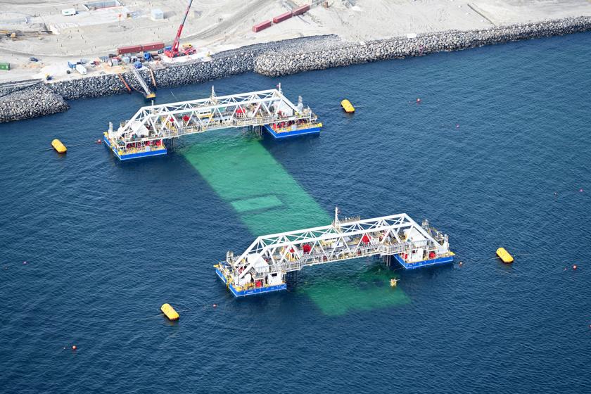 The first element for the Fehmarnbelt tunnel is immersed off the Danish tunnel portal. It is still connected to the two immersion pontoons, IVY 1 and IVY 2.