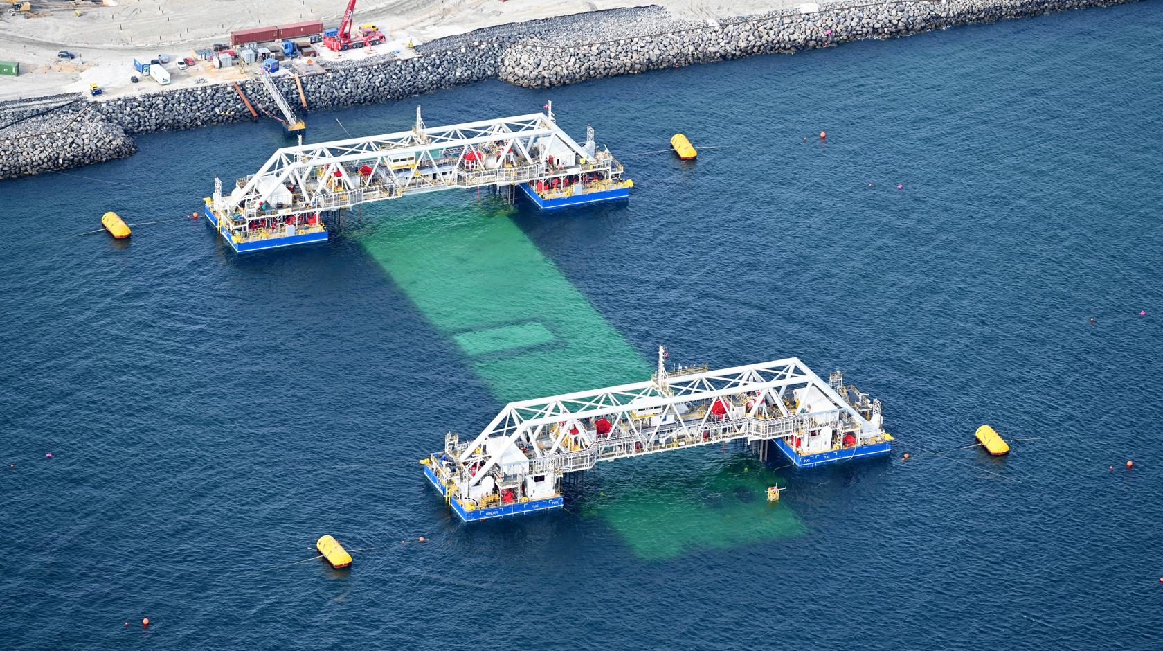 The first element for the Fehmarnbelt tunnel is immersed off the Danish tunnel portal. It is still connected to the two immersion pontoons, IVY 1 and IVY 2.