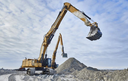 Two large excavators are working on the land reclamation site.