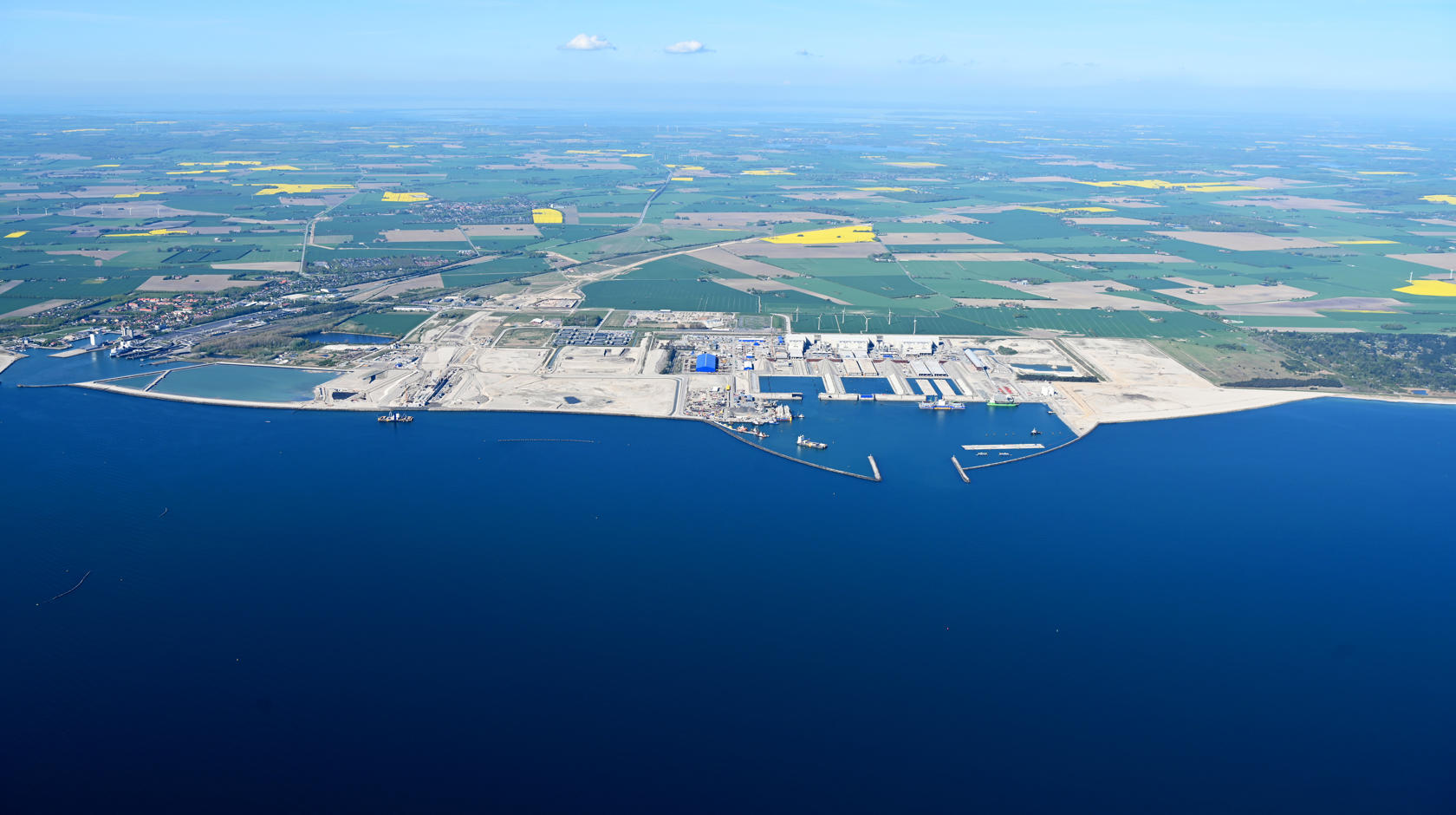View of the southern coast of Lolland on the Fehmarnbelt. The tunnel construction site is in focus.