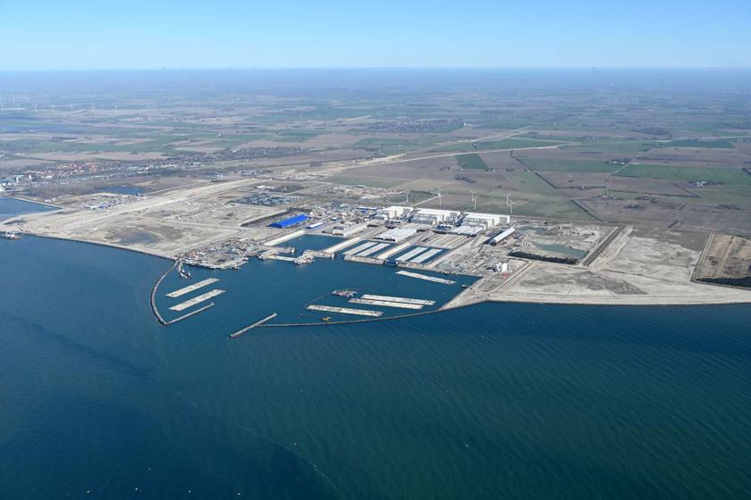 The Danish tunnel construction site. Several work vessels and a tunnel element are moored in the working harbour.
